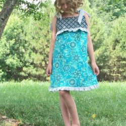 Child's Play dress sewing pattern by Whimsy Couture. This girls dress pattern has a cute partial front overlay with ruffle. It works great for all seasons.